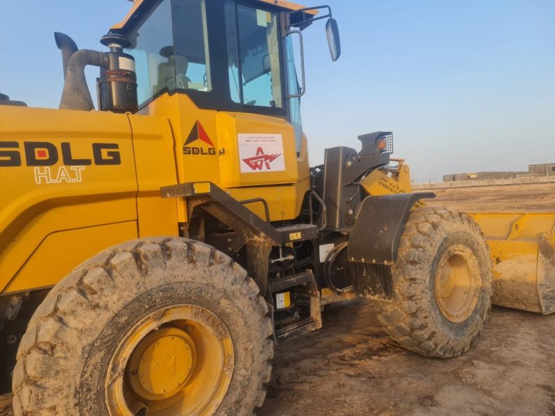 SDLG wheel loader handling material on site.